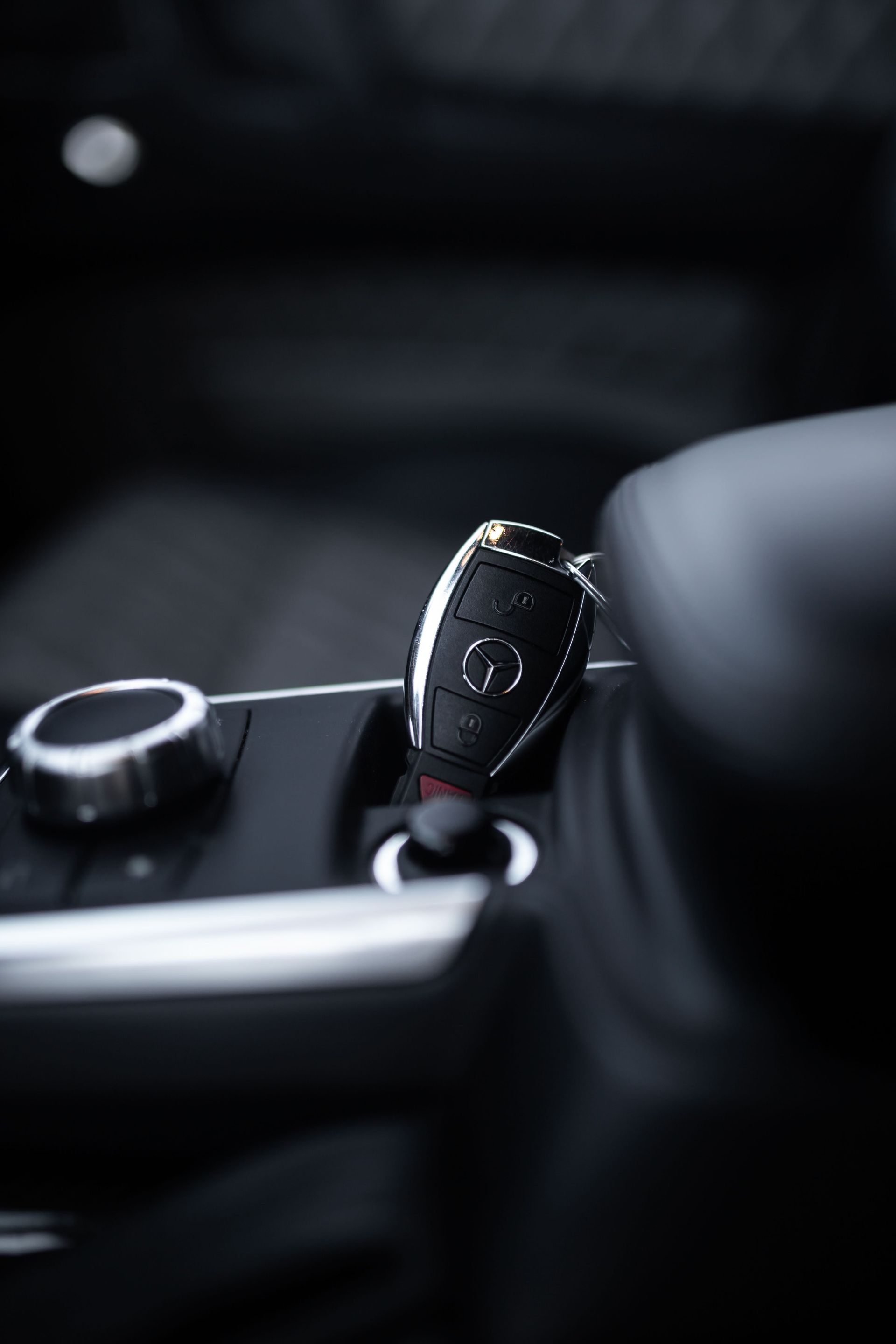 Car key inserted into lock blocking automated gear unit of modern car